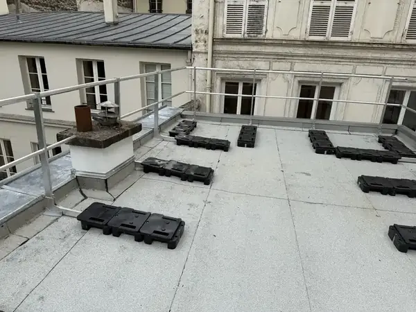 Toit terrasse d'un immeuble haussmannien à Paris 8e après travaux, plots répartis, garde-corps et entablement zinc